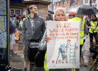 Anti-ULEZ protestors in Tooting Broadway London, Great Britain 
26th August 2023 

People campaigning to stop the ULEZ expansion which is due to commence on 29th August 2023 hold placards towards the traffic around Tooting Broadway