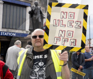 Anti-ULEZ protestors in Tooting Broadway London, Great Britain 
26th August 2023 

People campaigning to stop the ULEZ expansion which is due to commence on 29th August 2023 hold placards towards the traffic around Tooting Broadway