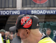 Anti-ULEZ protestors in Tooting Broadway London, Great Britain 
26th August 2023 

People campaigning to stop the ULEZ expansion which is due to commence on 29th August 2023 hold placards towards the traffic around Tooting Broadway