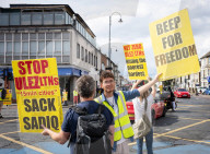 Anti-ULEZ protestors in Tooting Broadway London, Great Britain 
26th August 2023 

People campaigning to stop the ULEZ expansion which is due to commence on 29th August 2023 hold placards towards the traffic around Tooting Broadway