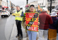 Anti-ULEZ protestors in Tooting Broadway London, Great Britain 
26th August 2023 

People campaigning to stop the ULEZ expansion which is due to commence on 29th August 2023 hold placards towards the traffic around Tooting Broadway