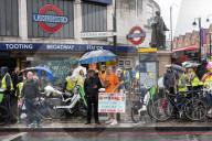 Anti-ULEZ protestors in Tooting Broadway London, Great Britain 
26th August 2023 

People campaigning to stop the ULEZ expansion which is due to commence on 29th August 2023 hold placards towards the traffic around Tooting Broadway
