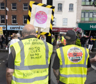 Anti-ULEZ protestors in Tooting Broadway London, Great Britain 
26th August 2023 

People campaigning to stop the ULEZ expansion which is due to commence on 29th August 2023 hold placards towards the traffic around Tooting Broadway