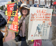 Anti-ULEZ protestors in Tooting Broadway London, Great Britain 
26th August 2023 

People campaigning to stop the ULEZ expansion which is due to commence on 29th August 2023 hold placards towards the traffic around Tooting Broadway