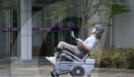 World's first wheelchair for climbing stairs and letting the user stand upright