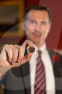 Jeremy Hunt UK Chancellor of the Exchequer showcases new coins of the nation