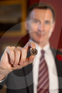 Jeremy Hunt UK Chancellor of the Exchequer showcases new coins of the nation