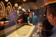 Shuffle board, axe-throwing and bingo: activity bar boom defies UK hospitality downturn