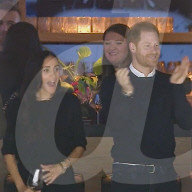 Harry and Meghan in good spirits at ice hockey game
