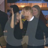 Harry and Meghan in good spirits at ice hockey game
