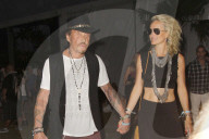 French singer Johnny Hallyday and wife Laeticia attend the Coachella Music Festival in Indio