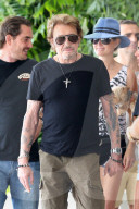 French singer Johnny Hallyday and his wife  Laeticia leaving their Miami Beach hotel