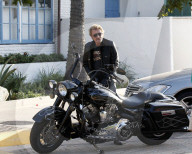 Johnny Hallyday hops on his motorcycle after having lunch with his wife Laeticia Boudou and daughter Jade in Los Angeles