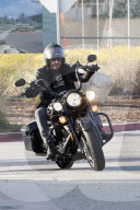 Johnny Hallyday hops on his motorcycle after having lunch with his wife Laeticia Boudou and daughter Jade in Los Angeles