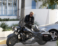 Johnny Hallyday hops on his motorcycle after having lunch with his wife Laeticia Boudou and daughter Jade in Los Angeles