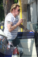 Veteran French singer Johnny Hallyday shops at Chrome Hearts on Melrose Blvd and cruises in a convertible blue classic car