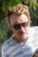 Veteran French singer Johnny Hallyday shops at Chrome Hearts on Melrose Blvd and cruises in a convertible blue classic car