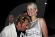 Legendary French singer and actor Johnny Hallyday turns on the charm with a blonde outside the Ed Hardy party in Los Angeles