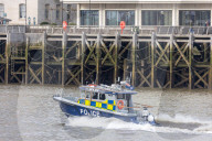 Police recover a body in the River Thames in London, UK.
