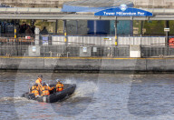 Police recover a body in the River Thames in London, UK.