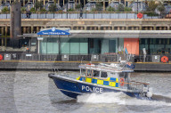 Police recover a body in the River Thames in London, UK.
