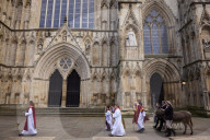 Donkeys lead the clergy and choir in procession into York Minster for the Palm Sunday Eucharist