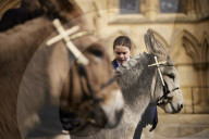 Donkeys lead the clergy and choir in procession into York Minster for the Palm Sunday Eucharist