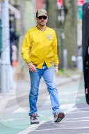 *EXCLUSIVE* Bradley Cooper plays it cool in a yellow bomber jacket with Muhammad Ali written on the front