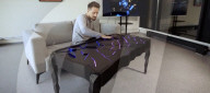 Interactive table has shape shifting surface and lights display