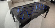 Interactive table has shape shifting surface and lights display