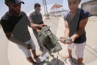 Palestinian youth lose some equipment and empty ammunition left by the Israeli army in along a street in the western part of Rafah, Rafah, Gaza Strip, Palestinian Territory - 14 Jun 2024
