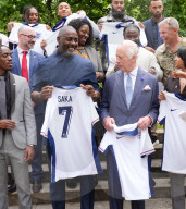 King Charles and Idris Elba with England football shirts