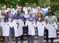 King Charles and Idris Elba with England football shirts