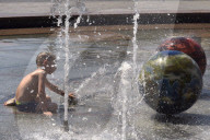 Bathing in Vinnytsia fountain on hot summer day, Ukraine