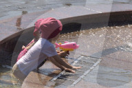 Bathing in Vinnytsia fountain on hot summer day, Ukraine