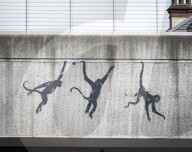 Banksy Three Monkeys artwork on a bridge in Brick Lane, London, UK.