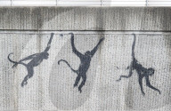 Banksy Three Monkeys artwork on a bridge in Brick Lane, London, UK.