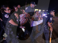 Ferguson officer in critical condition with brain injury after Michael Brown protest turns violent