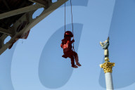 Sculpture of girl on swing by James Colomina in Kyiv