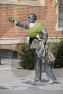 Campaigners tie baby slings to statues in call for better UK paternity leave.