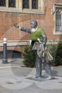 Campaigners tie baby slings to statues in call for better UK paternity leave.