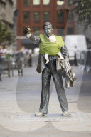 Campaigners tie baby slings to statues in call for better UK paternity leave.