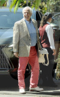 Henry Winkler, 78, gazes at his own memoir and carries a bag with the image of the late Farrah Fawcett as he emerges from a two hour lunch at a fancy eatery in Beverly Hills