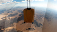 Suitcase dropped from space lands without a scratch