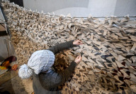Volunteers weave winter camouflage nets for Ukraine Military