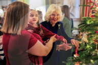 Queen Camilla decorates a Christmas tree with children