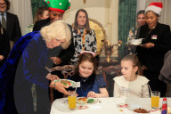 Queen Camilla decorates a Christmas tree with children