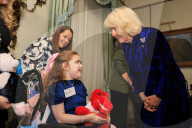 Queen Camilla decorates a Christmas tree with children