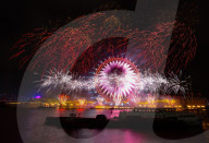 25th Anniversary of London’s New Year’s Eve fireworks display as seen from the RAF Memorial on the Embankment overlooking the river Thames towards the Coca-cola London Eye. 
31st December 2024