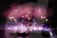 25th Anniversary of London’s New Year’s Eve fireworks display as seen from the RAF Memorial on the Embankment overlooking the river Thames towards the Coca-cola London Eye. 
31st December 2024